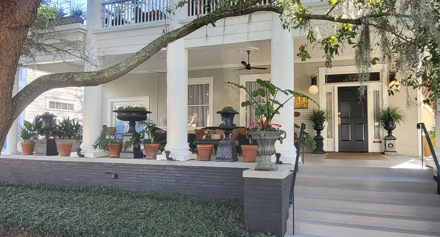 A white house with a large porch and columns